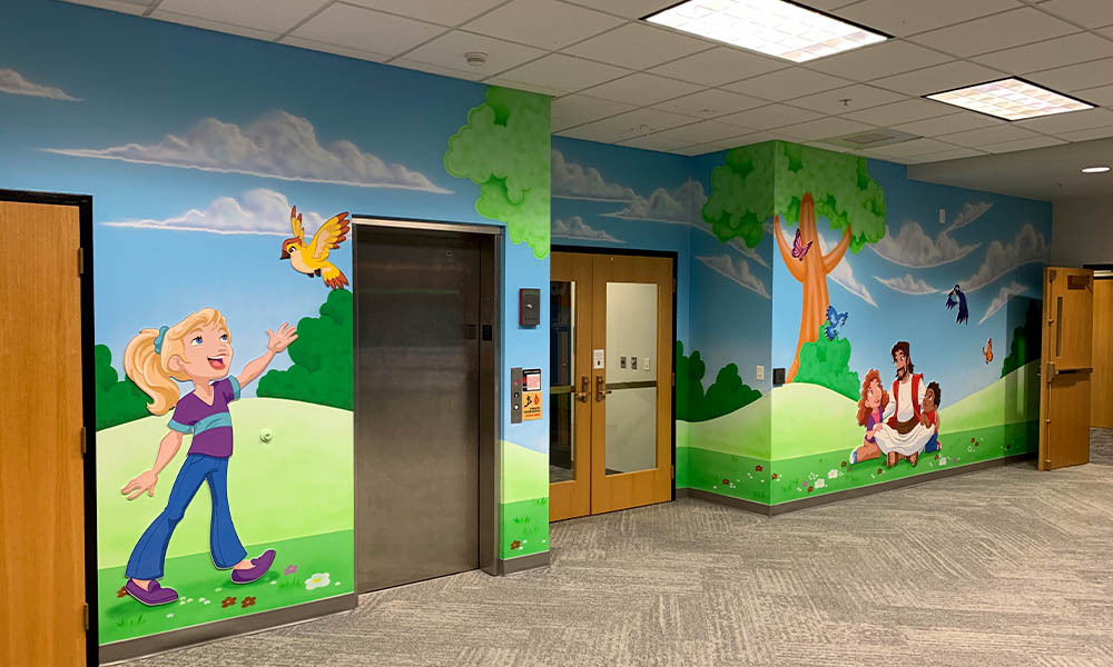 Jesus sitting with children wall mural down a kids church hallway